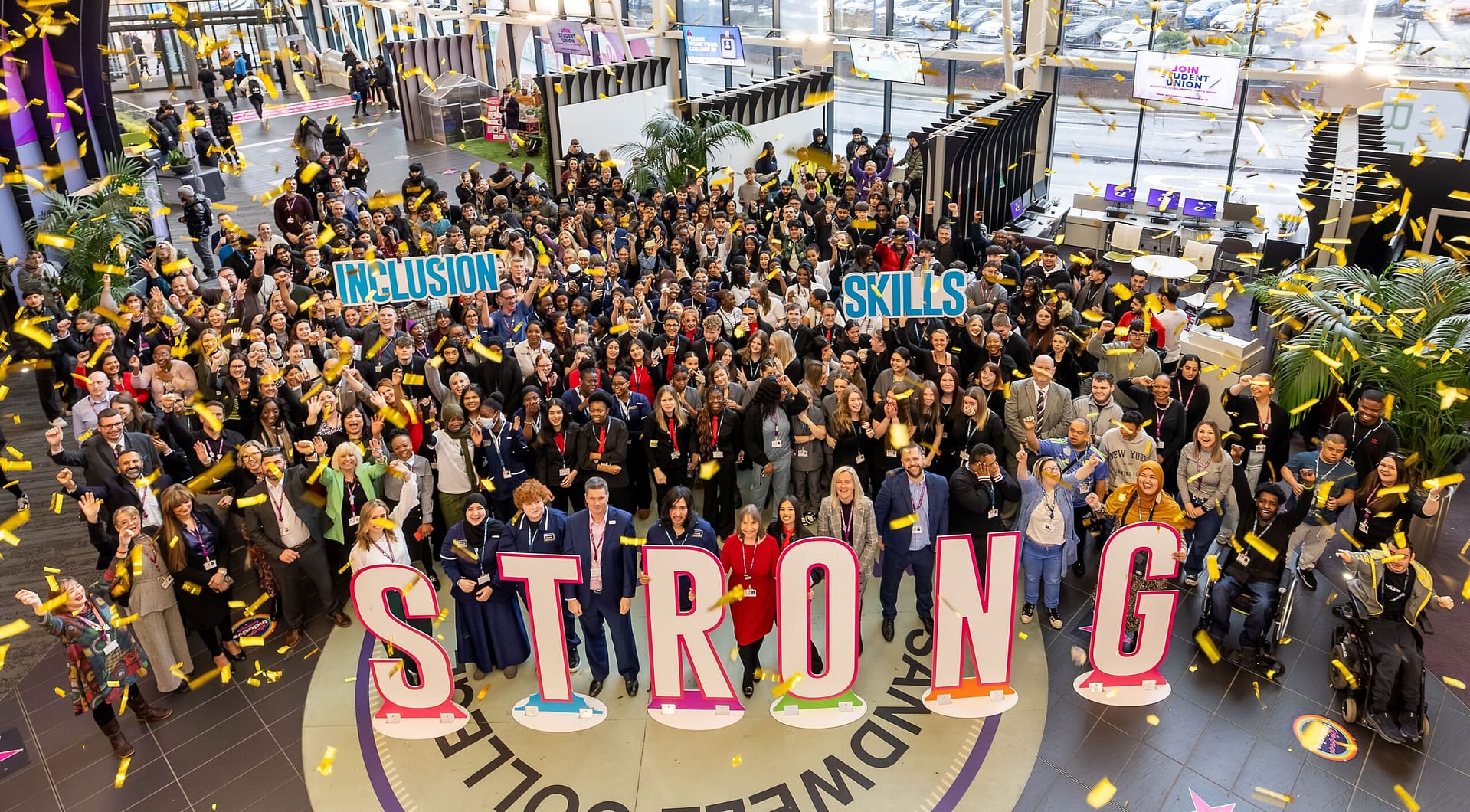pic of students and staff with the word 'STRONG' spelled out