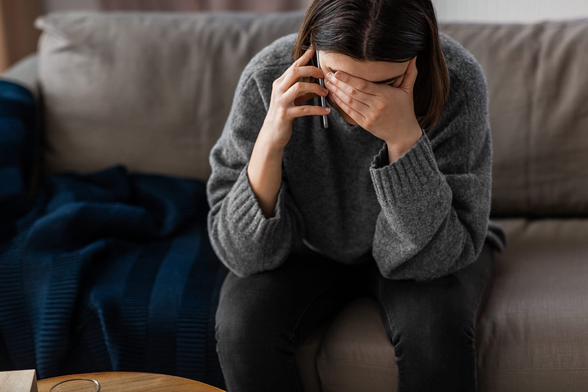 stressed woman with medicine calling on phone